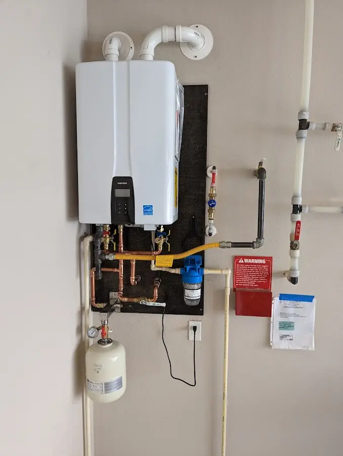 Professional plumber installing copper piping in a East Rochester home