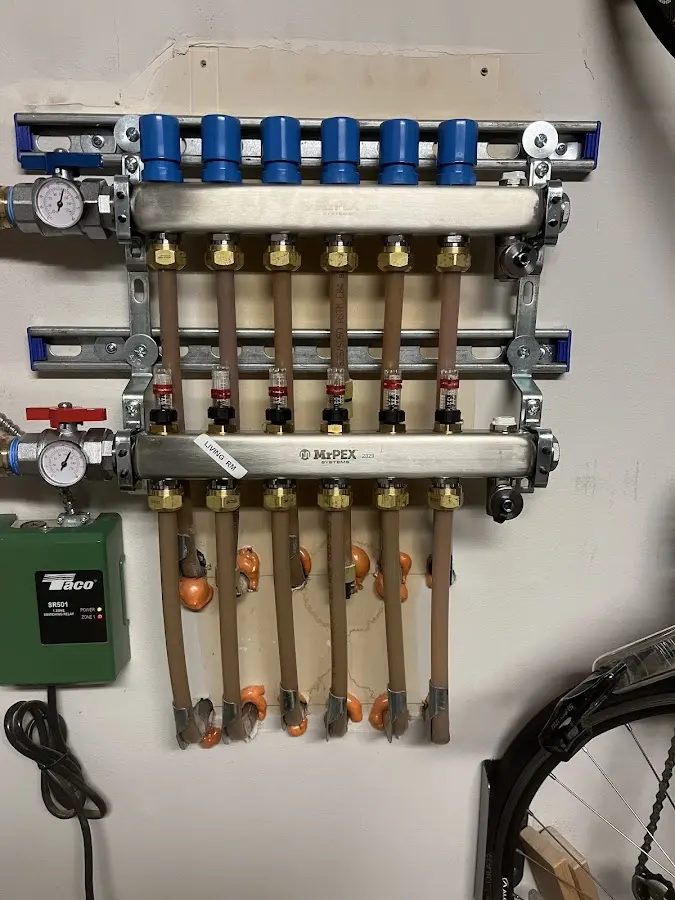 Plumber performing Water Heater Repair at a residential property in East Rochester